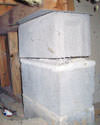 Concrete crawl space support posts in Union City that are showing signs of failure as they sink into the earth.