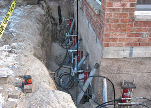 Foundation push piers installed around a house with a foundation settlement issues in Linden, NJ