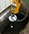 Installing a helical pier during a foundation repair in NYC