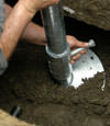 NYC helical pier installation nearing completion, with the blade being advanced into the foundation soils.