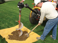 Auguring a hole in the earth for a foundation wall repair system in Perth Amboy
