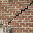 stair step cracking reaching from a window along the foundation wall in Elizabeth
