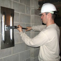 installing a wall anchor to repair an bowing foundation wall in East Orange