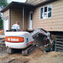 Excavating to expose the foundation walls and footings for a replacement job in Bayonne
