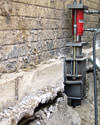A completed installation of foundation push piers lifting a foundation in Lakewood