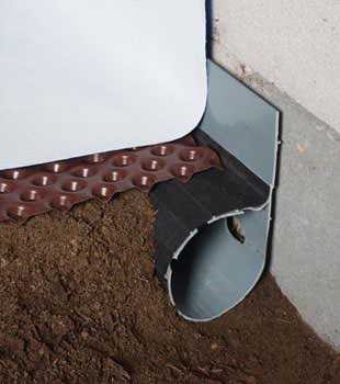Closeup of a crawl space drainage system installed in Irvington